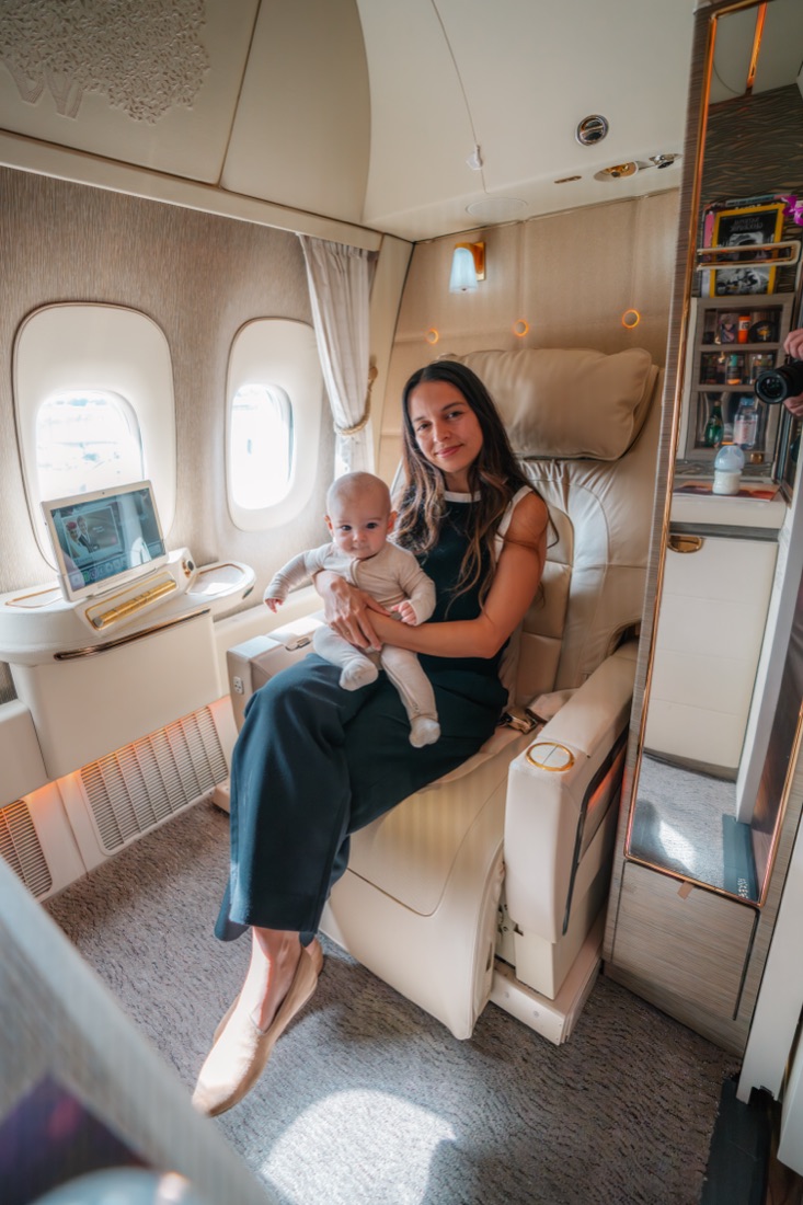 Catarina holding baby Louie in an Emirates First Class suite
