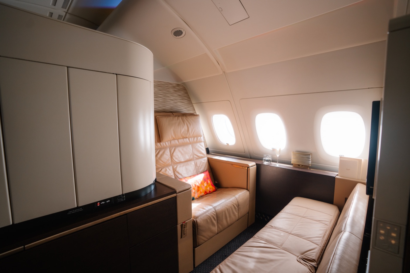 Etihad First Apartment with a leather seat and a separate bed